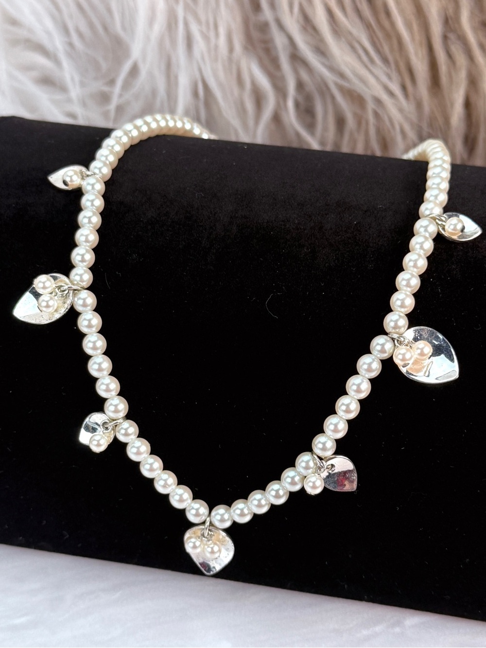 Pretty faux pearl with silvertone charm accents, necklace